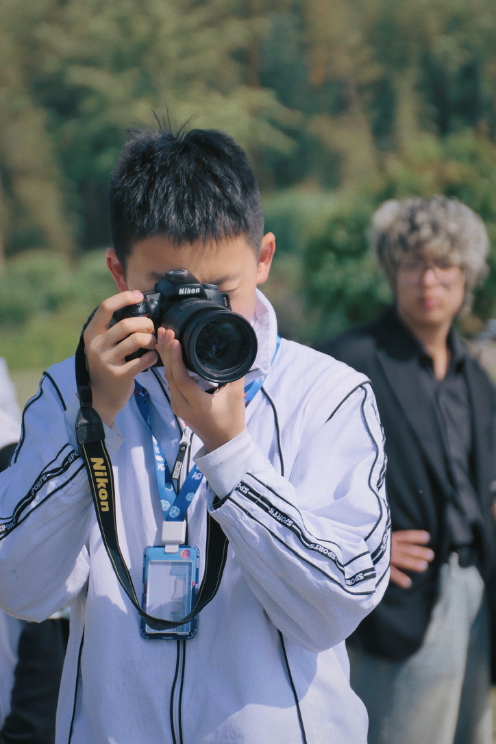 Jackson shooting with a Nikon camera during outdoor fieldwork